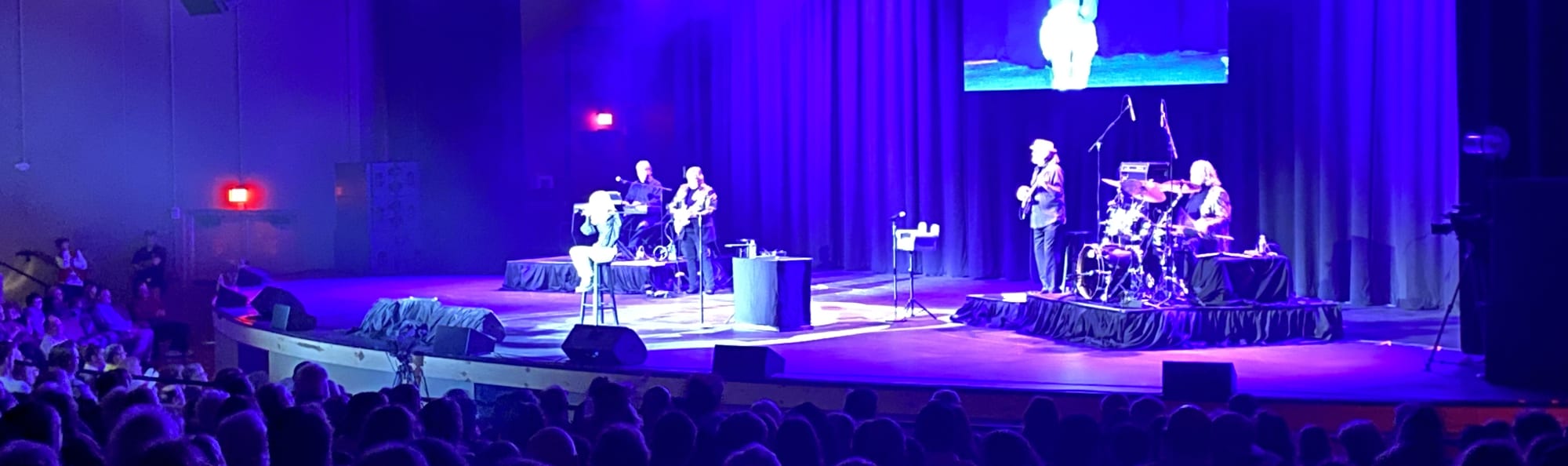 signer on stage in chair washed out by the lights Austin